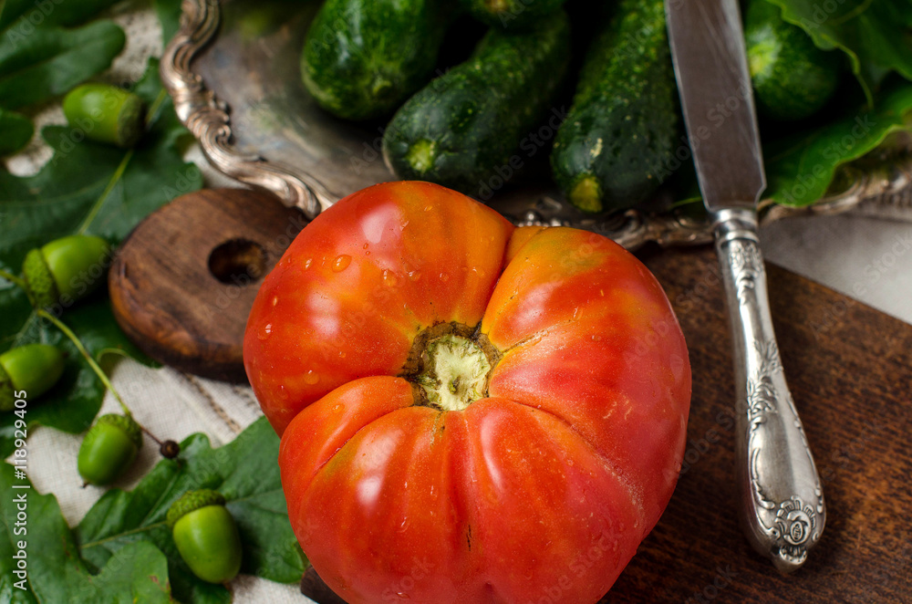 Large tomato and a knife. Large tomato and a knife.