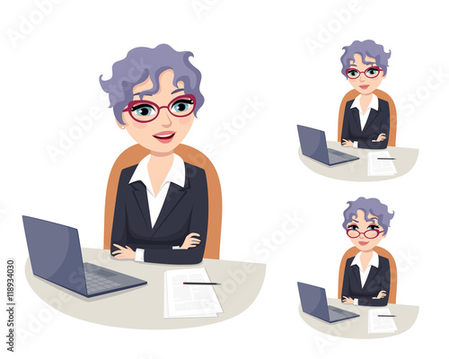 friendly female CEO wearing glasses sitting at her desk in the office