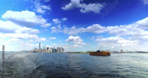 The skyline of lower Manhattan with the Staten Island Ferry in the foreground headed into port.  	