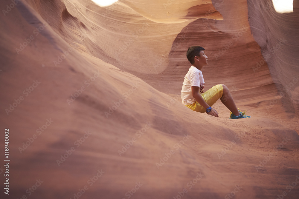 Chinese boy traveling in Antelope Canyon, USA - obrazy, fototapety, plakaty 