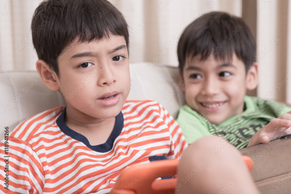 Little sibling boy playing game on mobile together Little sibling boy playing game on mobile together