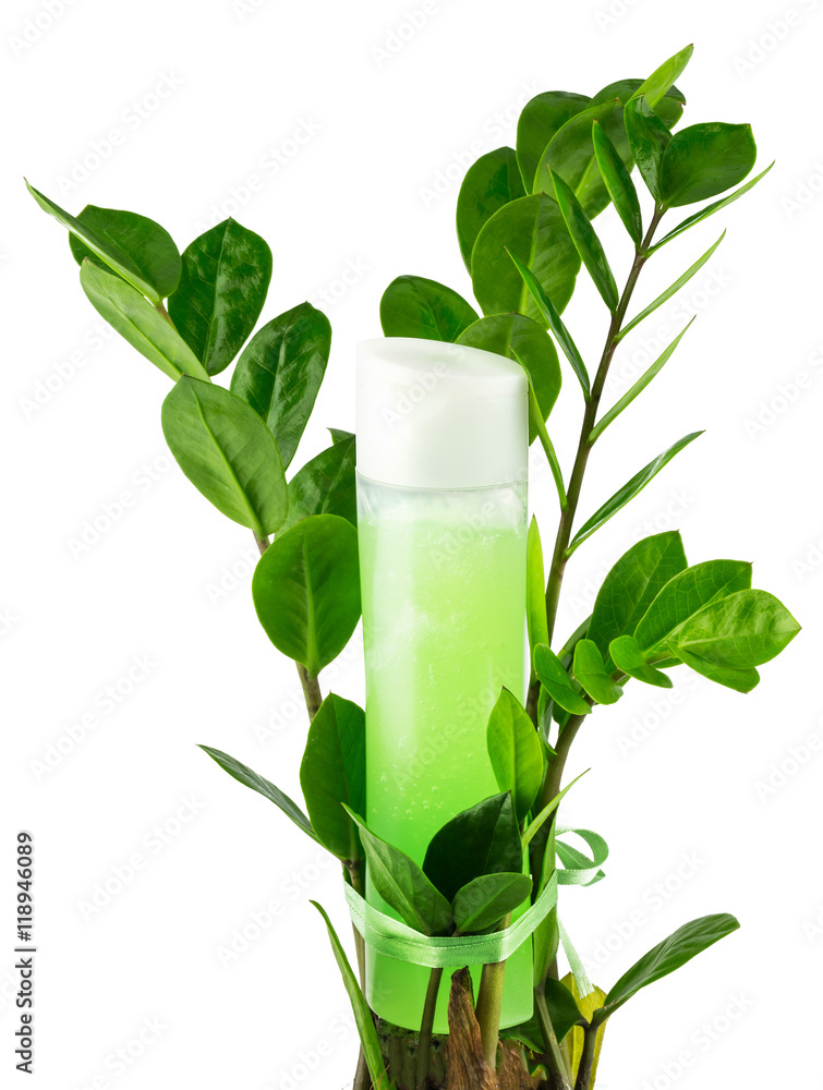 Natural organic herbal liquid green product in a plastic bottle with plant Natural organic herbal liquid green product in a plastic bottle with plant