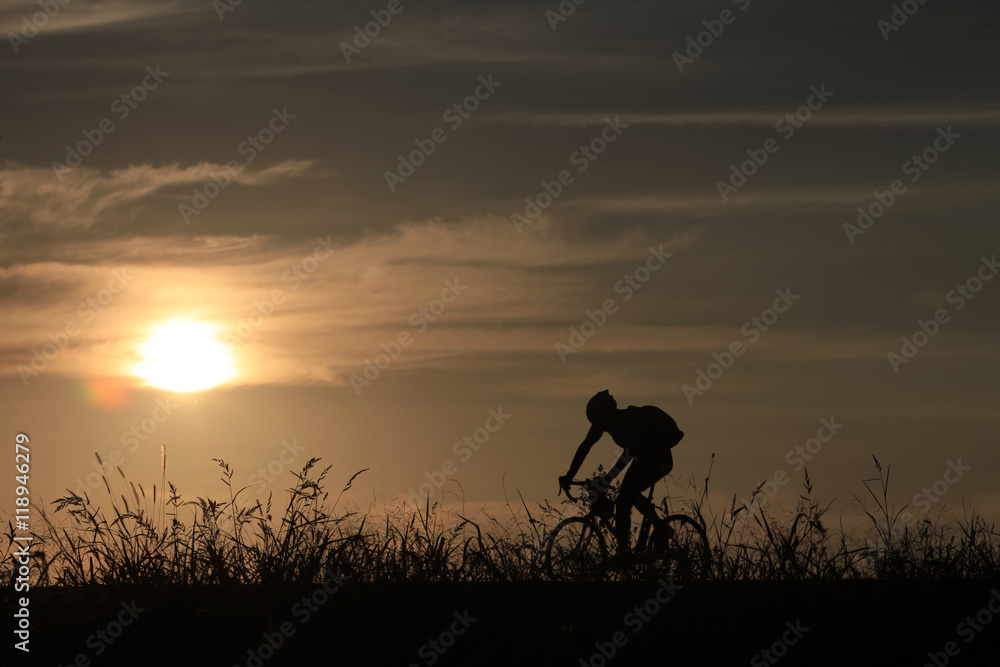 Riding a bike in sunset