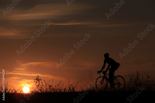 Riding a bike in sunset
