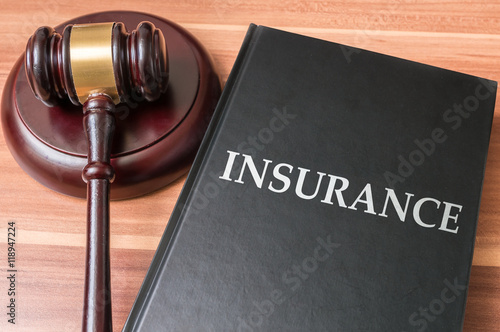Book with insurance laws. Justice and legislation concept.