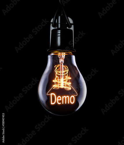 Hanging lightbulb with glowing Demo concept. photo