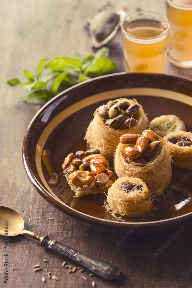 Plate with traditional syrian knafeh on table Plate with traditional syrian knafeh on table