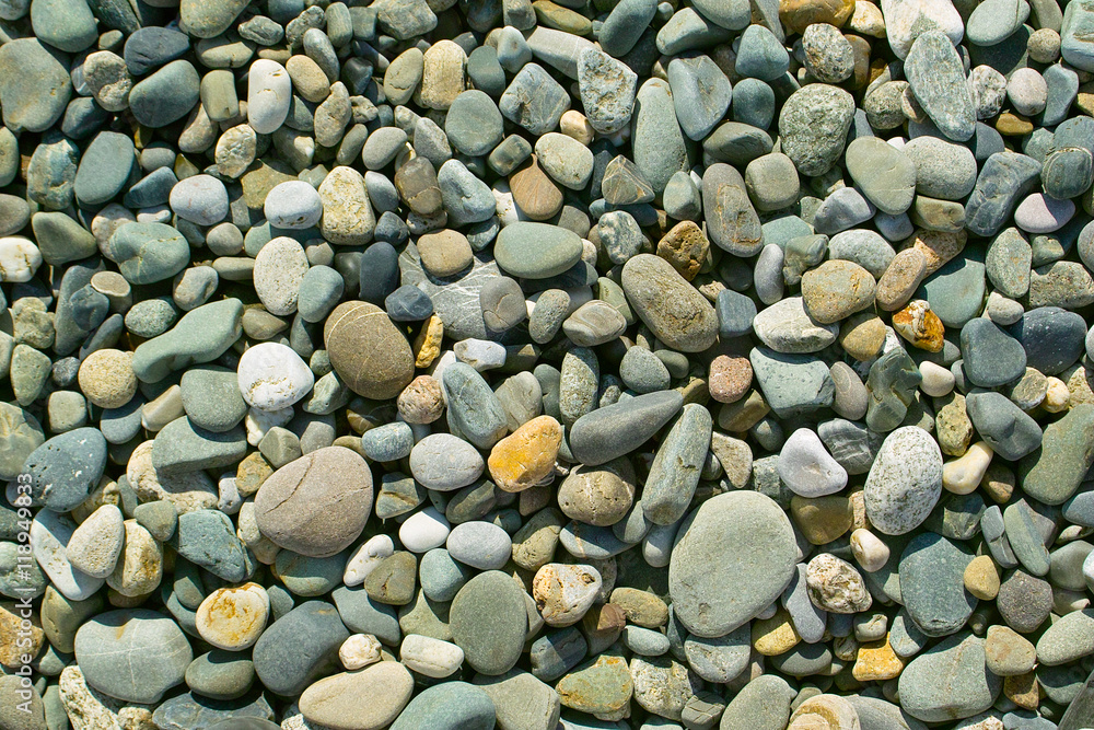 Sea stones pebble background. Sunny beach rocks Sea stones pebble background. Sunny beach rocks