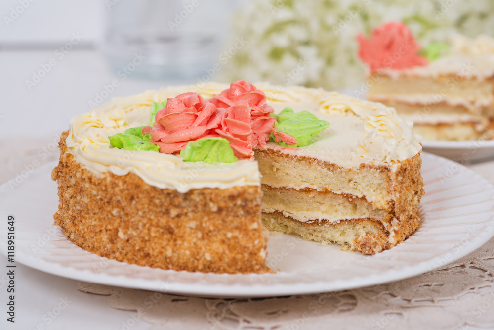 Creamy cake on plate on table on light background Creamy cake on plate on table on light background