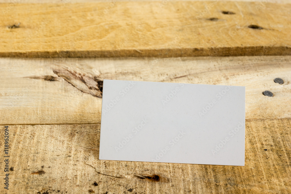 White blank business visit card, gift, ticket, pass, on wooden table. 