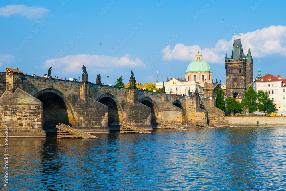 Charles Bridge, aka Karluv most, and Vltava river in Prague city centre on sunny summer day with blue sky, Czech Republic