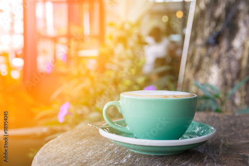 green coffee cup on wooden table