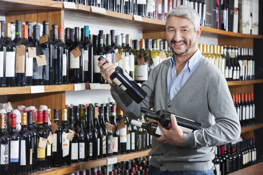 Male Customer Shopping For Wine Bottles In Store