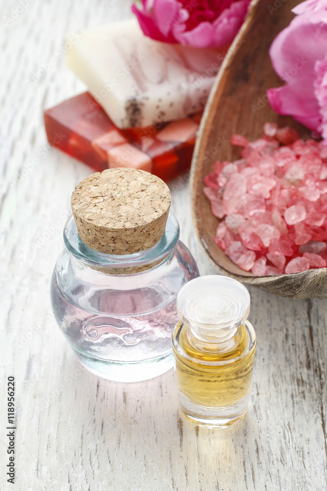 Bottles of essential oil and bowl of red sea salt Bottles of essential oil and bowl of red sea salt