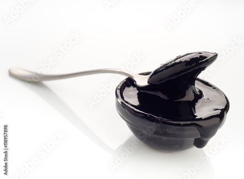 spoon with concentrated paste squid ink on white