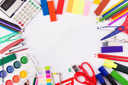 Various office supplies arranged as frame on a white background. Back to school. Top view with copyspace