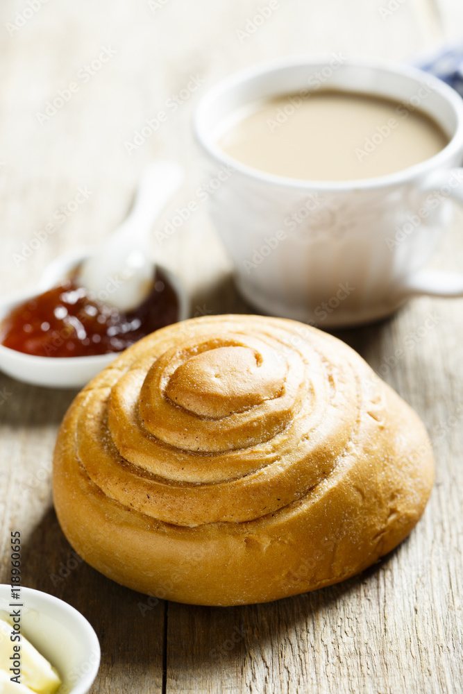 Breakfast table, served with coffee, jam and fresh bun Breakfast table, served with coffee, jam and fresh bun