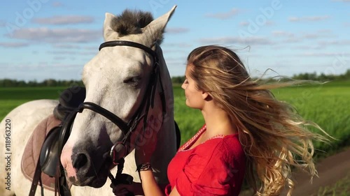 Portrait of young beautiful woman dreesed in red with white horse near the field HD photo