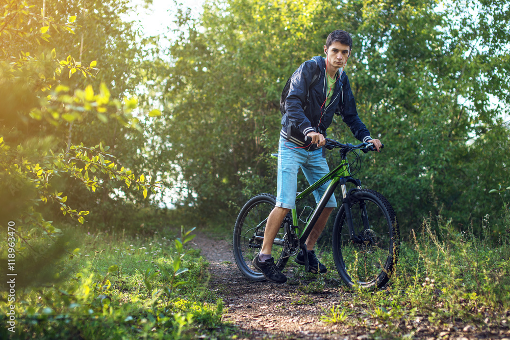 Naklejka premium Mountain biker rides a Bicycle in the morning
