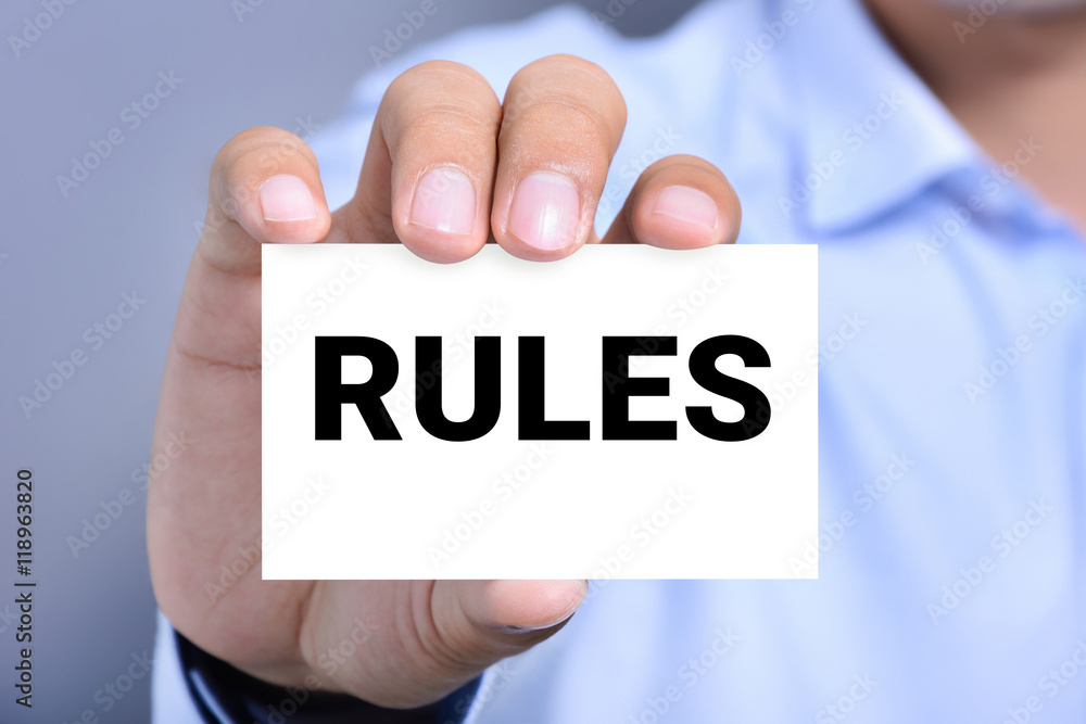 RULES word on the card shown by a man RULES word on the card shown by a man