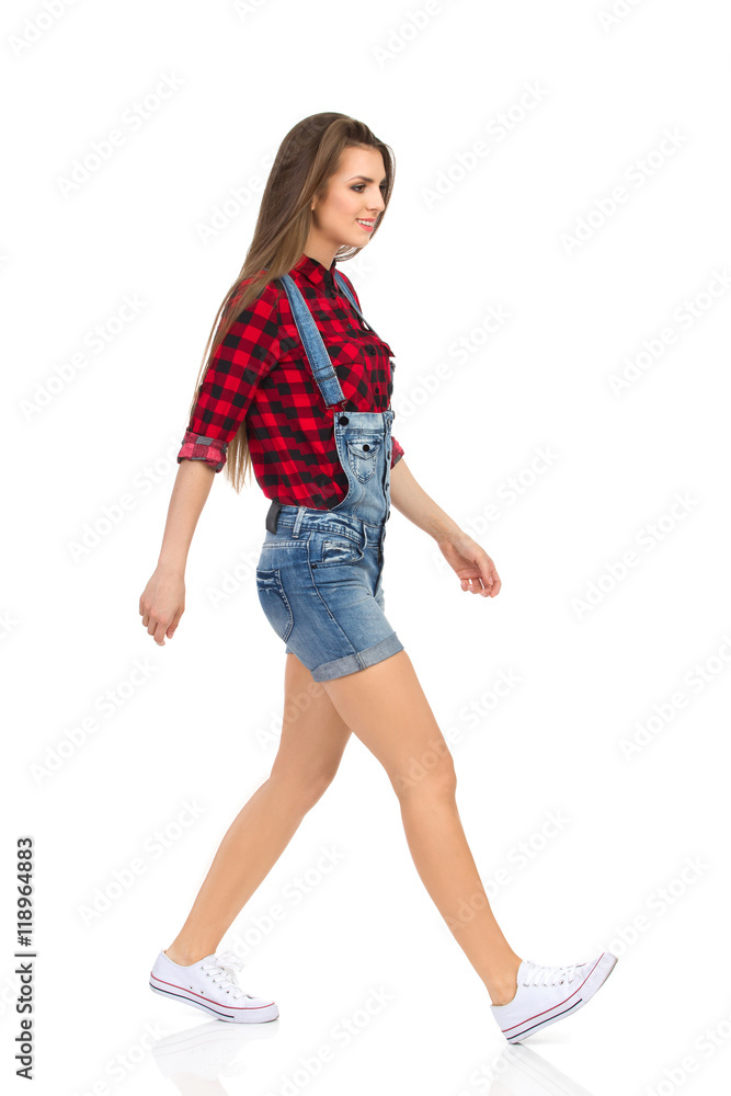 Walking Young Woman In Dungarees Side View Walking Young Woman In Dungarees Side View