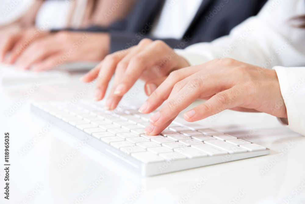 Hands typing on computer keyboards Hands typing on computer keyboards