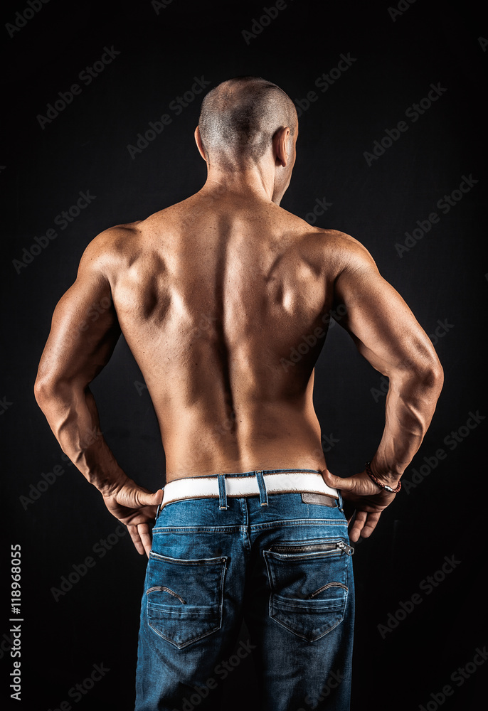 very muscular handsome athletic man on black background very muscular handsome athletic man on black background