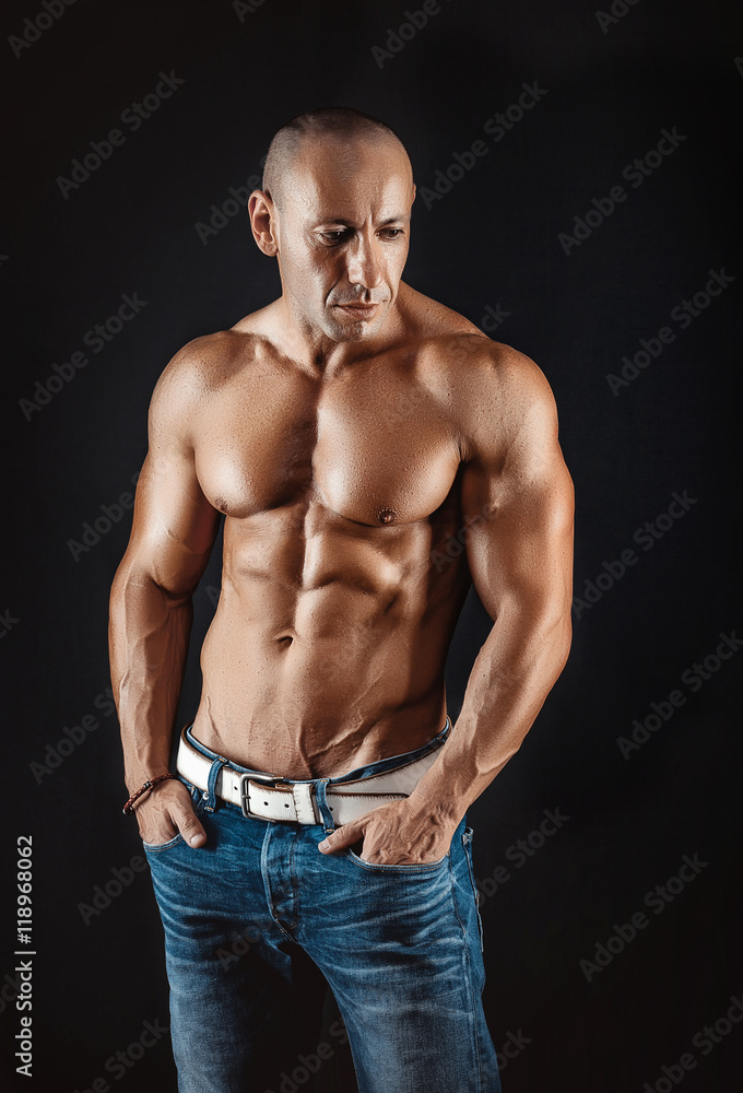 very muscular handsome athletic man on black background very muscular handsome athletic man on black background