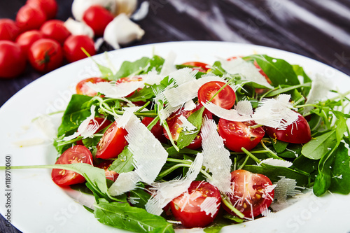 Close-up shot of tomatoes and arugula salad