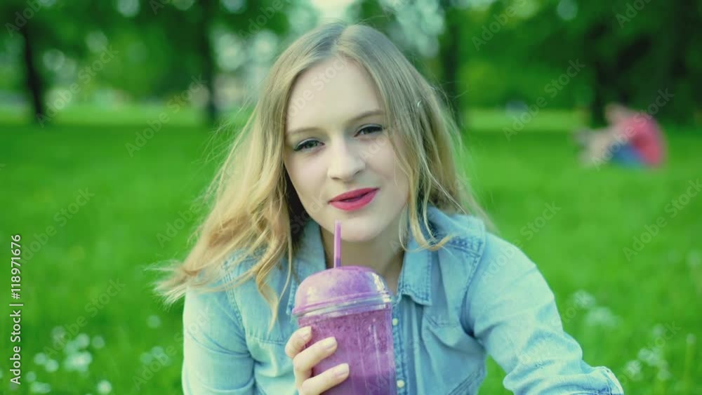Pretty girl smiling to the camera and drinking fruity cocktail, steadycam shot
Pretty girl smiling to the camera and drinking fruity cocktail, steadycam shot