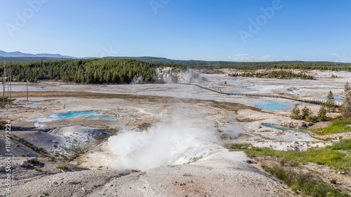 Amazing landscape of small geysers, hot springs, and vents. Ledge Geyser. The barren snow-colored basin. Porcelain Basin of Norris Geyser Basin, Yellowstone National Park, Wyoming