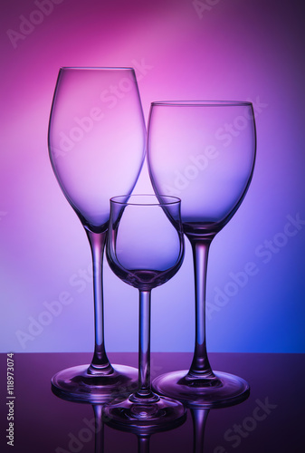 Three different wine glass on a color background