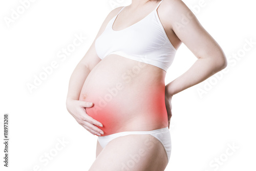 Caucasian pregnant woman in white lingerie with back and abdominal pain isolated on white background