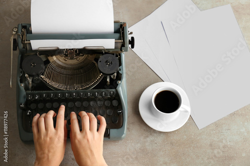 Woman typing on the typewriter, top view