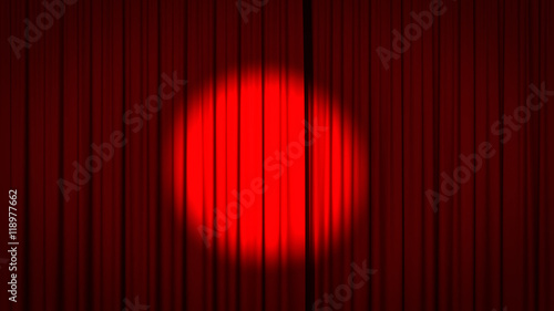 Red stage curtain with a spotlight in the center.