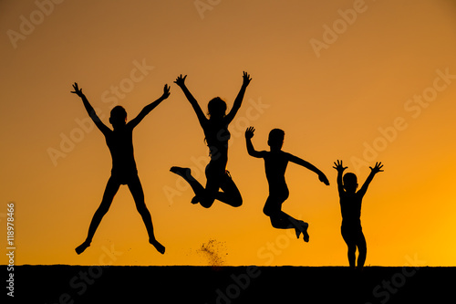 silhouette of jumping kids against sunset © Sergiy Bykhunenko
