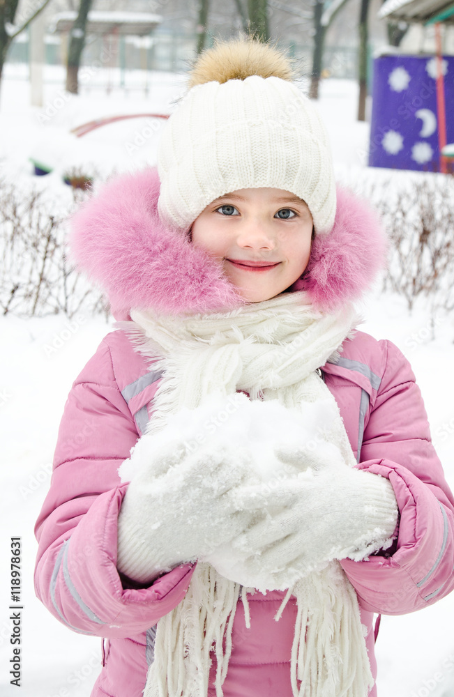 Fototapeta premium Portrait of adorable smiling little girl in winter day