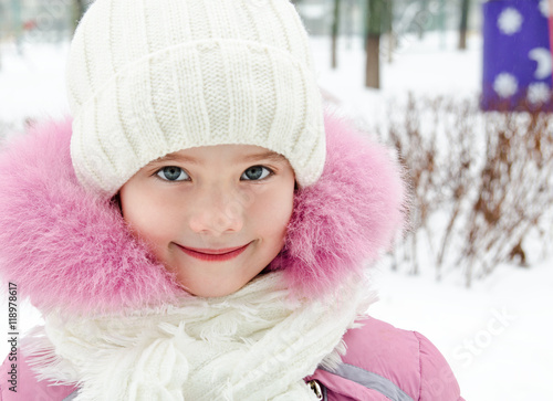 Portrait of adorable smiling little girl in winter day