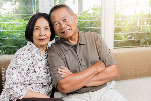 Happy senior Asian couple smiling at home