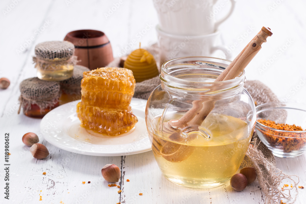 jar of honey with honeycomb on wooden table jar of honey with honeycomb on wooden table