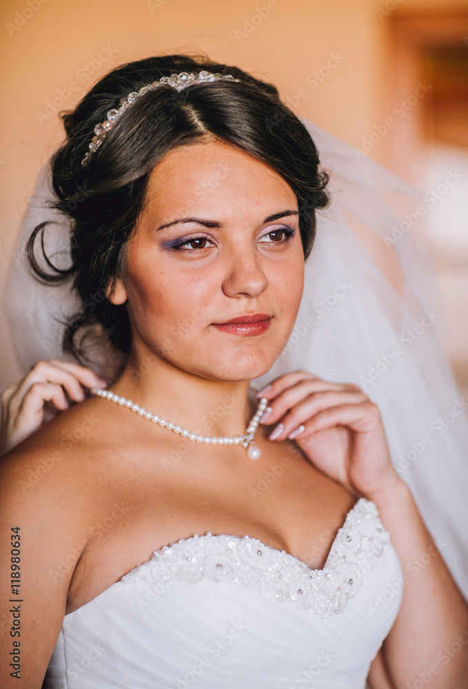 Happy buddies helps bride getting ready for her wedding day in the morning
