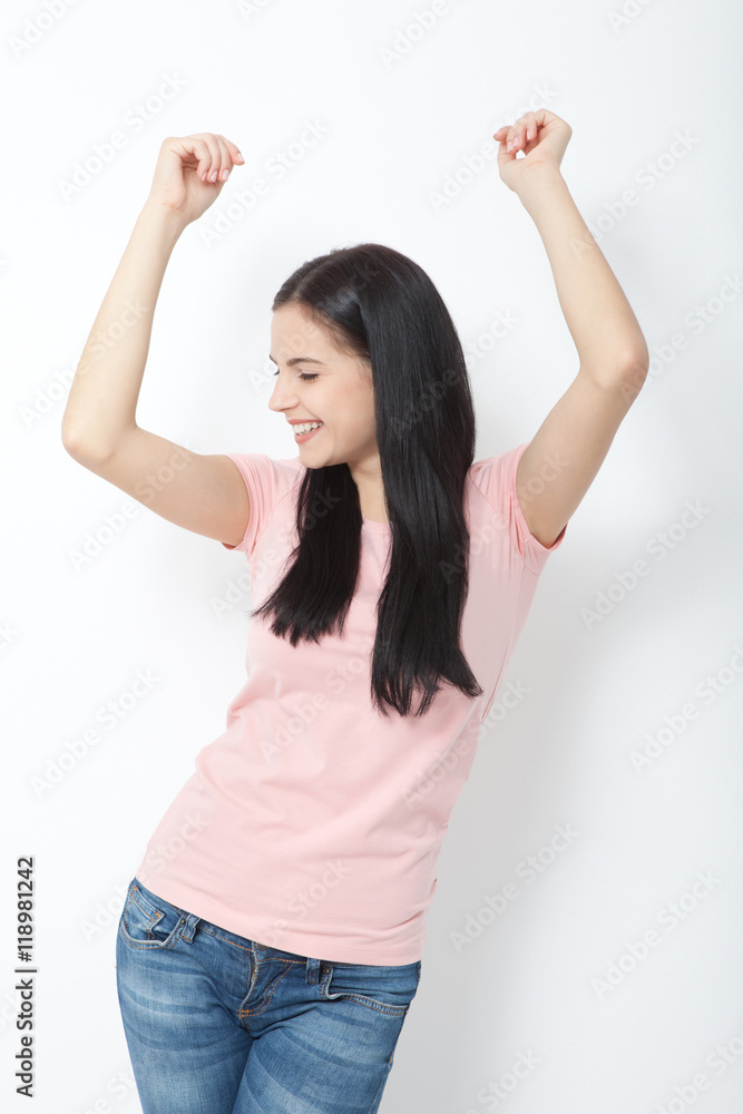 Portrait of happy young woman dancing on white background Portrait of happy young woman dancing on white background