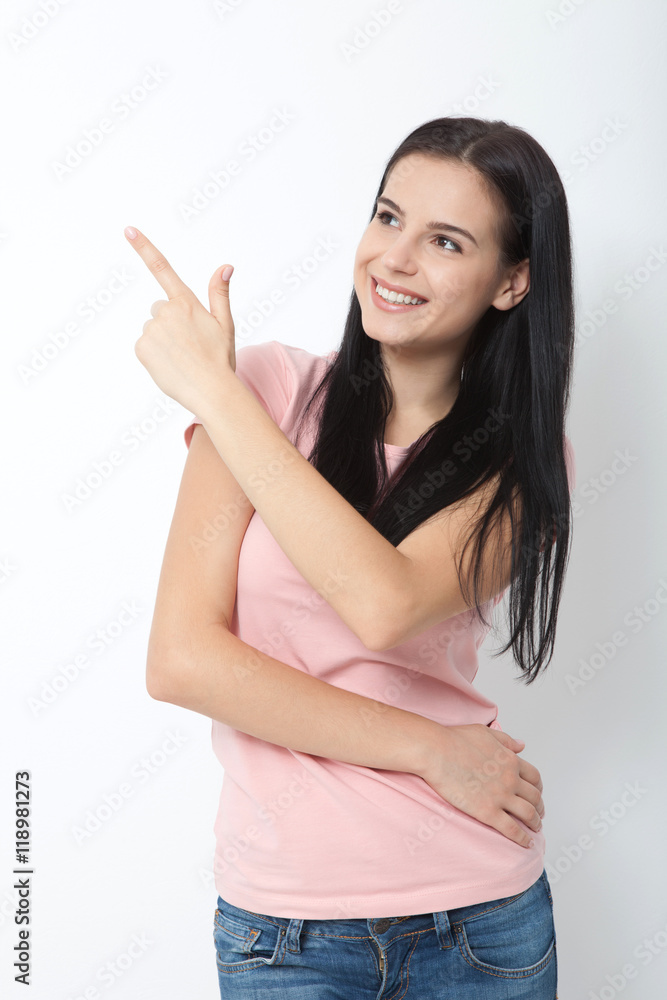 Friendly smiling woman pointing at copyspace isolated on white background Friendly smiling woman pointing at copyspace isolated on white background