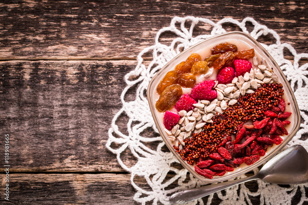 Breakfast banana smoothie bowl topped with goji berries,raspberry