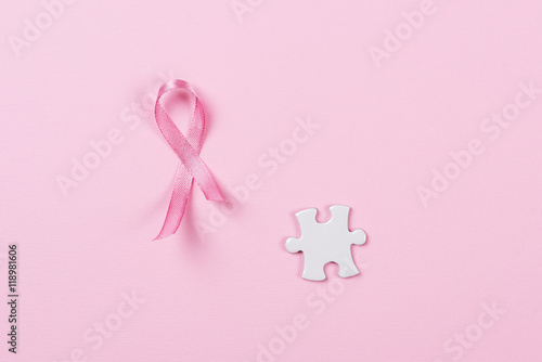 Pink ribbon and puzzle pieces breast cancer.
