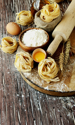 Uncooked pasta with flour on the table, selective focus