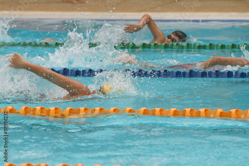 A group of swimmer swimming freestyle stroke in a swimming pool for competition or race
