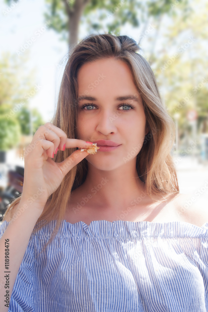 cute long haired woman model in blue blouse eat and make joke outdoor cute long haired woman model in blue blouse eat and make joke outdoor