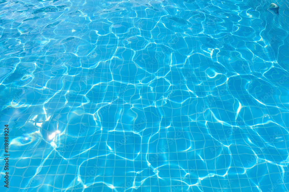 Beautiful water surface in swimming pool with sun reflection