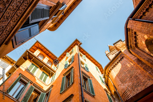 View from below on the old buildings with window shutters in Verona city center in Italy